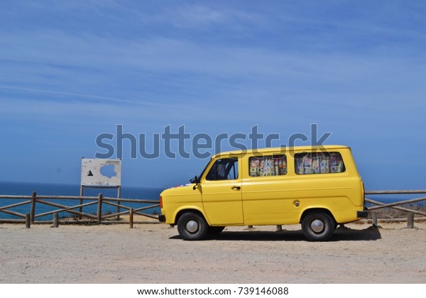 Yellow bus on van life vacation, Almocageme,\
Portugal, Europe