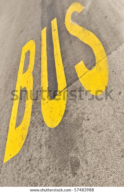 Yellow Bus sign painted\
on the asphalt