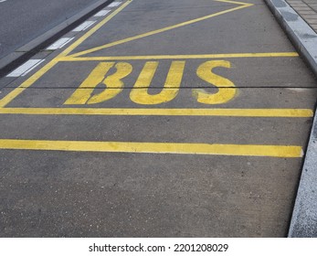 Yellow Bus Stop Lane Sign On Concrete