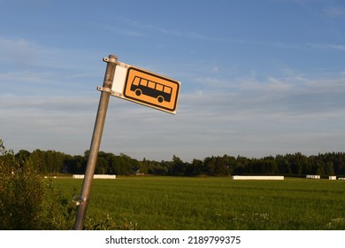 Yellow Bus Stop Sign In The Countryside