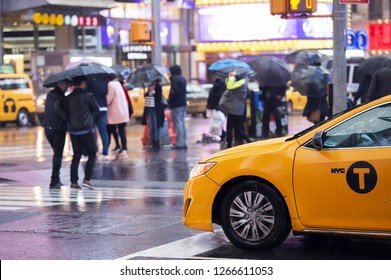  Yellow Cab Speeds Through Times Square, The Busy Tourist Intersection Of Neon Art And Commerce. Times Square Is Also An Iconic Square Of New York City.