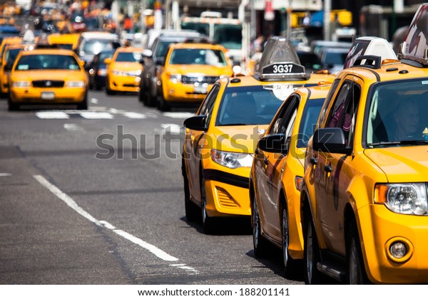 Yellow cab speeds through Times Square in New York, NY,\
USA. 