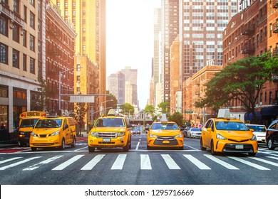 Yellow Cabs Waiting For Green Light On The Crossroad Of Streets Of New York City During Sunny Summer Daytime