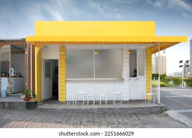 Yellow cafe or food booth or restaurant or coffeshop or coffee shop exterior building, outdoor with blue sky - Powered by Shutterstock