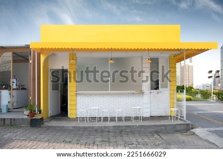 Yellow cafe or food booth or restaurant or coffeshop or coffee shop exterior building