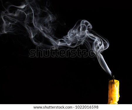 Yellow Candle with white smoke on black background / Select focus for adjustment  make smoke brush tool