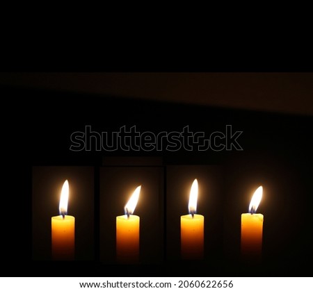 Yellow Candles Burning in the Dark with lights glow. The burning candle's flame in the dark background. a symbol of the Christian faith. Candles Burning in the Dark with lights glow