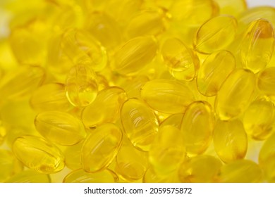 A lot of yellow capsules pills that were zoomed in