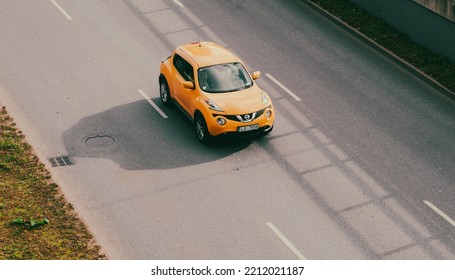 Yellow Car Is Driving On The Street. Nissan Juke From Above. Riga, Latvia, 10.08.2022