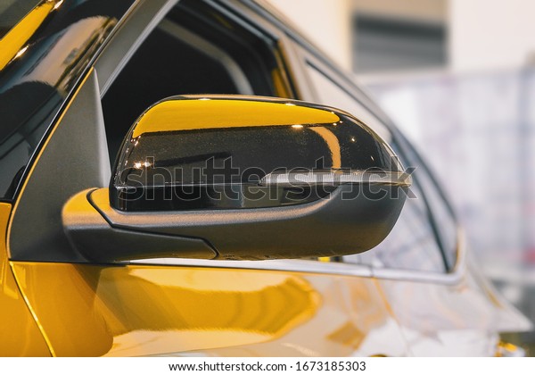 yellow car side mirror\
with built-in led turn signal, part of the SUV exterior, yellow car\
color taxi