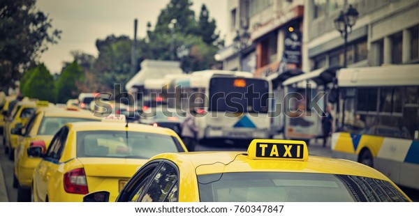 yellow cars of the taxi on the city street and on\
the color photo in retro\
style