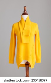 Yellow Cashmere Sweater With Wood Model On Grey Isolated