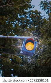 A yellow caution light installed in front of a school gate, emphasizing safety and awareness. Ideal for themes of education, safety measures, and school zones