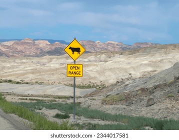 Yellow caution road sign in Utah desert. Cattle symbol. Open range. Watch for grazing animals. - Powered by Shutterstock