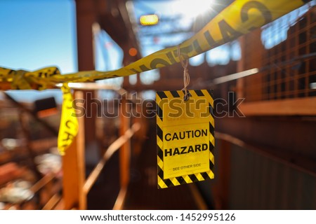 Yellow caution sign/ symbols tag applying on the entry construction workplace to ensure safety warning precaution in place from public access construction site Sydney 
