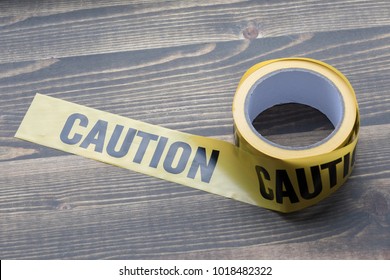 yellow caution tape on a wooden background. Safety Barrier For Police Barricade, For Contractors