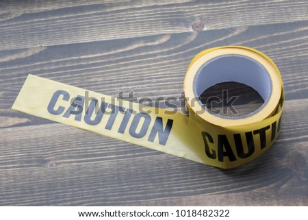 yellow caution tape on a wooden background. Safety Barrier For Police Barricade, For Contractors