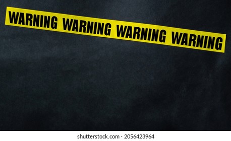 Yellow caution tape stripe with words warning. Concept of danger, security and protection - Shutterstock ID 2056423964