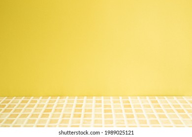 Yellow ceramic mosaic tile table. yellow wall background. Home interior - Powered by Shutterstock