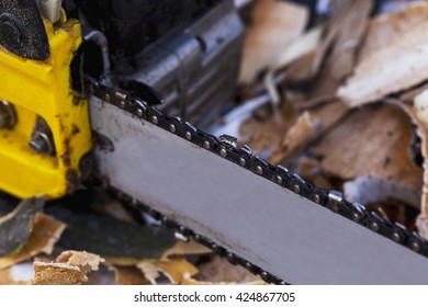 The Yellow Chainsaw Is On A Ground