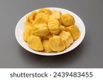 Yellow Champedak sliced in white plate and gray background. Ripe jackfruit in white plate.