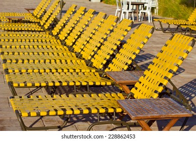 Yellow Chase Lounge Chairs At A Tropical Resort. 