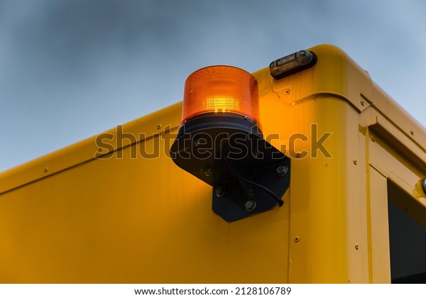Yellow city\
sewer cleaning service truck. Equipment for hydraulic flushing of\
urban sewerage. Signal flashing\
beacon.