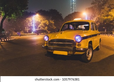 Yellow classic taxi service at Kolkata airport parking at night - Powered by Shutterstock