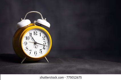 Yellow Clock Isolated On Dark Background