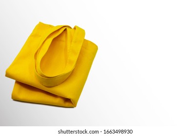 Yellow cloth bag placed on the left isolated on white background. - Shutterstock ID 1663498930