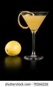 Yellow Cocktail In Martini Glass Isolated On Black Background