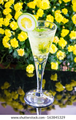 yellow cocktail with a slice of lime