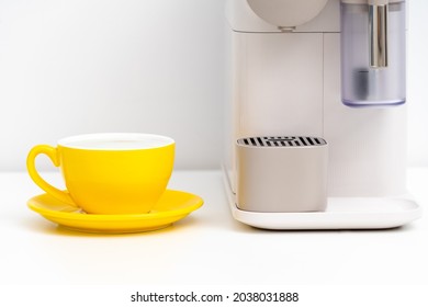 Yellow coffee cup and Coffee Capsule Machine