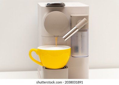 Yellow coffee cup and Coffee Capsule Machine