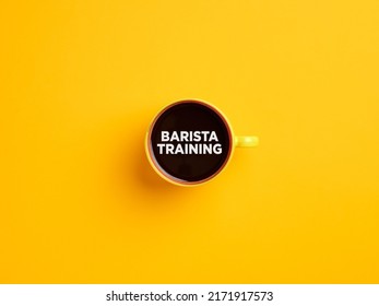 Yellow Coffee Cup On Yellow Background With The Message Barista Training.