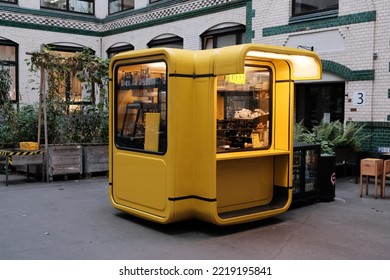 Yellow Coffee Kiosk In A Yard