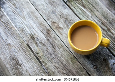 Yellow Coffee Mug On Rustic Wooden Table