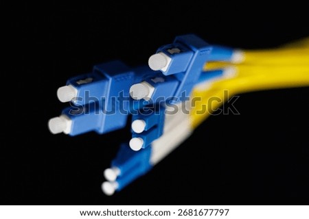 Yellow coiled fiber optic patch cord with blue connectors SFP modules are essential for high-speed data transmission over fiber optic networks.