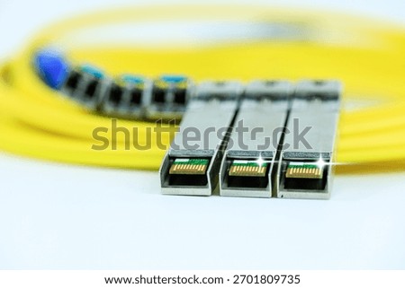 Yellow coiled fiber optic patch cord with blue connectors SFP modules are essential for high-speed data transmission over fiber optic networks.