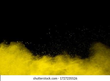 Yellow Color Powder Explosion On Black Background.