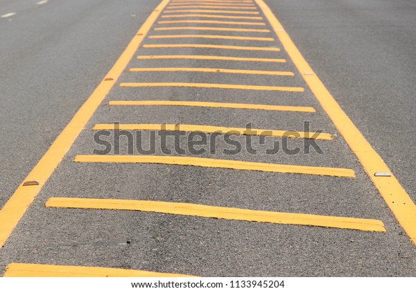 Yellow color road\
line on asphalt\
background