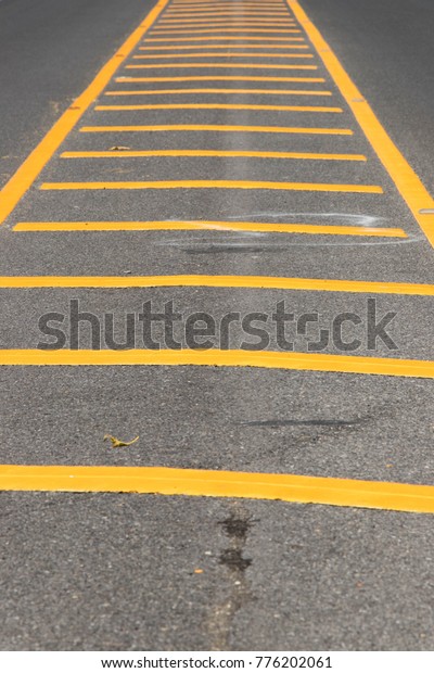 Yellow color road\
line on asphalt\
background