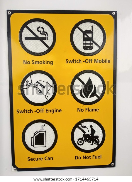 A yellow color safety poster at a petrol station\
- Karachi Pakistan + apr 2020