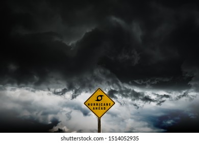 Yellow Color Warning Sign Plate Symbol Or Signal Of Hurricane Season Ahead Stand Through A Dark Thunderstorm Cloud, The Beautiful Power Of Nature For The Global Environment Background Concept