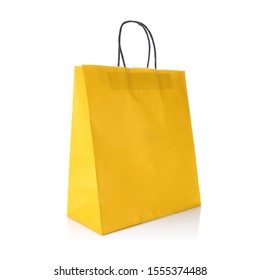 Yellow colour kraft paper gift bag with handle for easy carry. Cut out on white background. Eco & reusable shopping bag for groceries, gifts, goodies. Design template for Mock up, Branding, Advertise - Shutterstock ID 1555374488