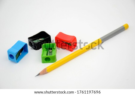the yellow colour wooden peel pencil with four colourfull sharpner isolated on white background.