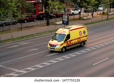 Yellow Coloured MediUrg Ambulance Driving Down A Major Street Of Bucharest, Romania, August 7, 2019