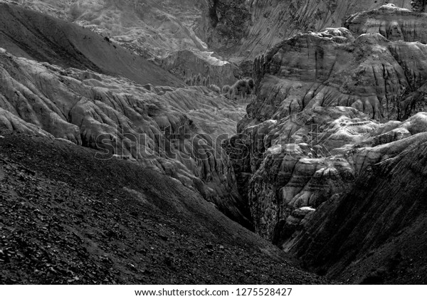 Yellow colourful\
rocks and stones - formation like moon surface on earth , place\
called moonland, mountains , ladakh landscape Leh, Jammu and\
Kashmir, India. Black and white\
image.