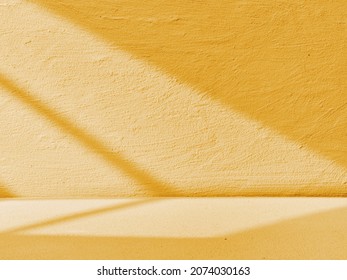 Yellow concrete background with light from the window
