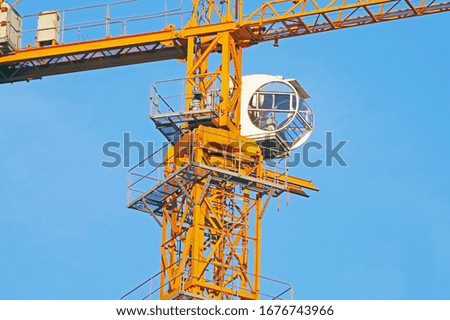 Similar – Image, Stock Photo Yellow construction crane and tree trunks in front of a blue sky